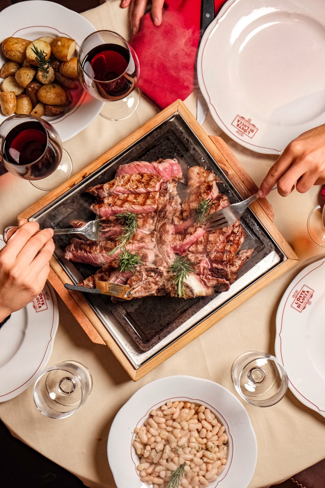 Bistecca alla Fiorentina served on scorching soapstone at L&rsquo;Oste di Lucca